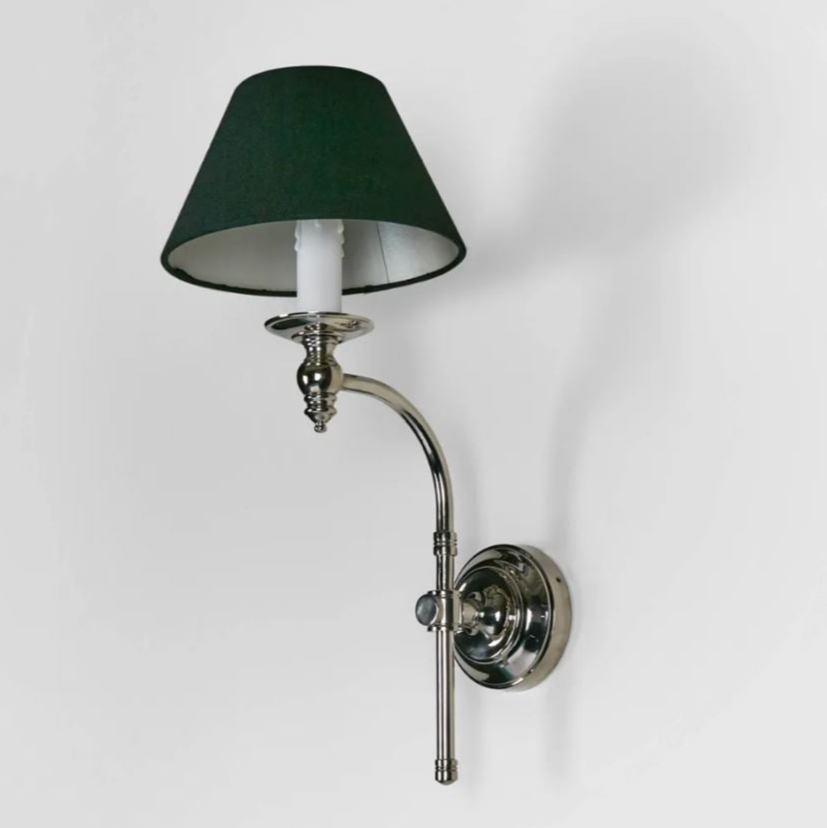 Wall-mounted lamp with a black shade and chrome arm on a white background