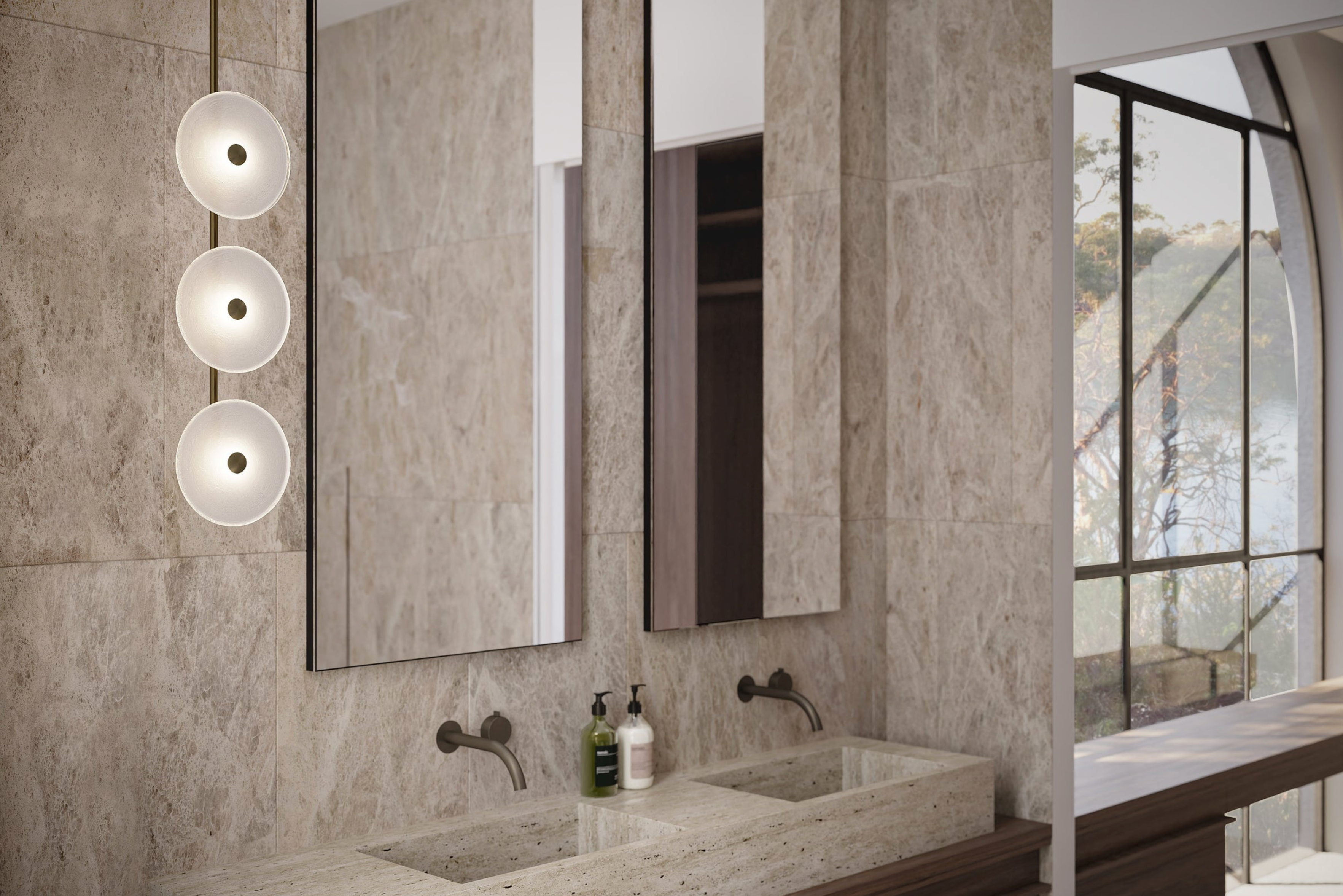 Modern bathroom with marble walls, sinks, and glass lighting fixtures.