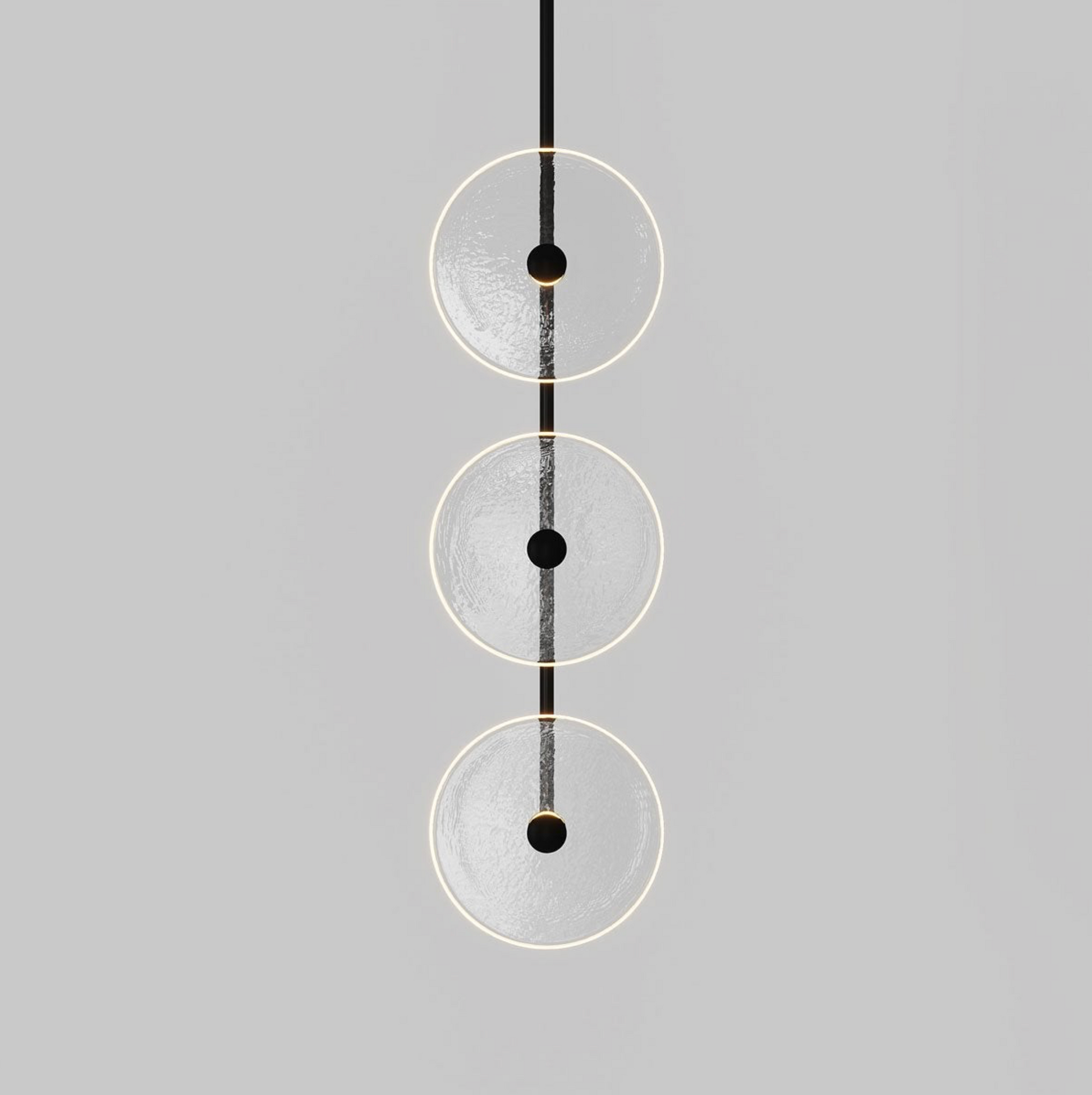 Modern pendant light with three circular shades on a gray background
