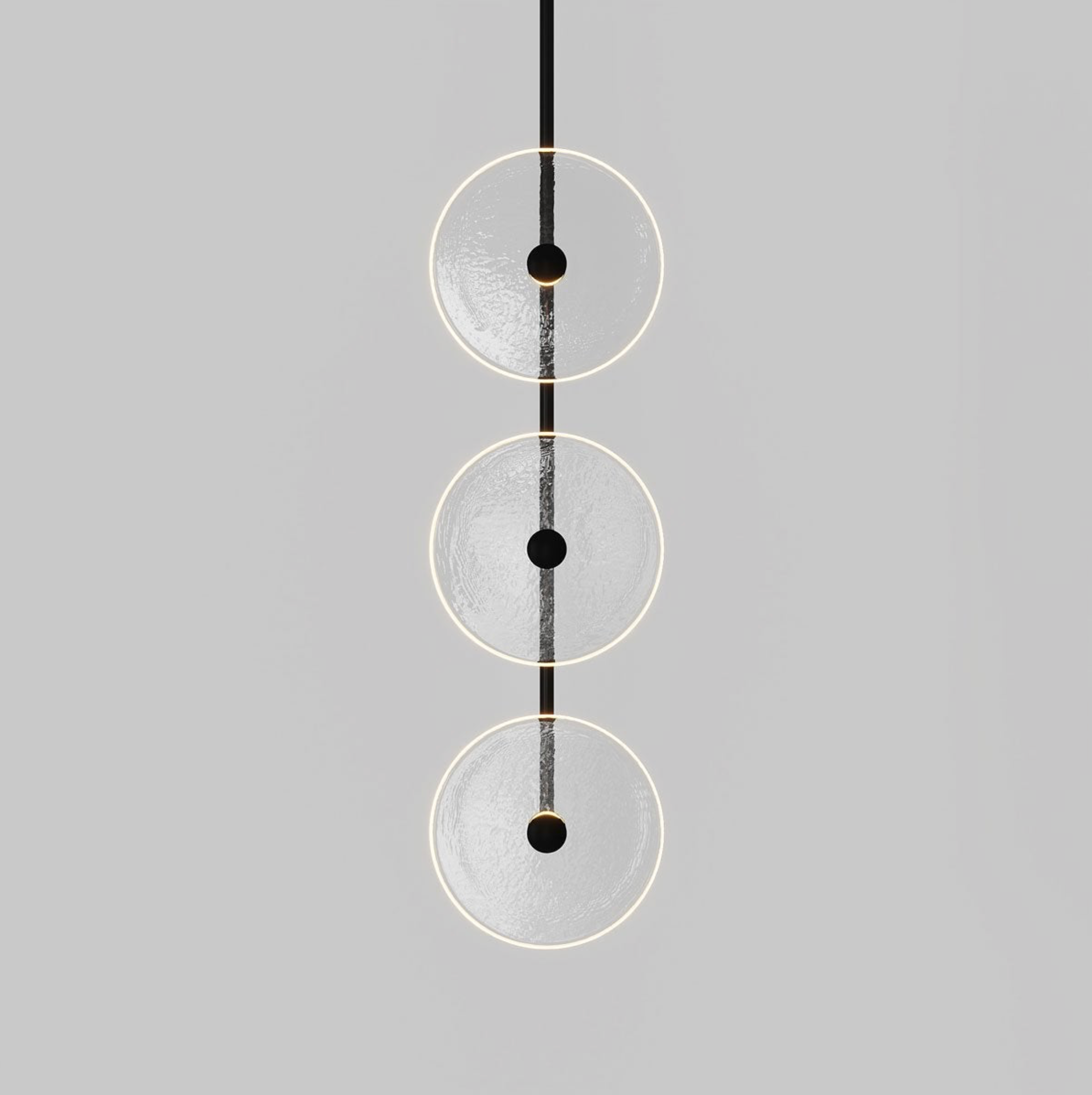 Modern pendant light with three circular shades on a gray background