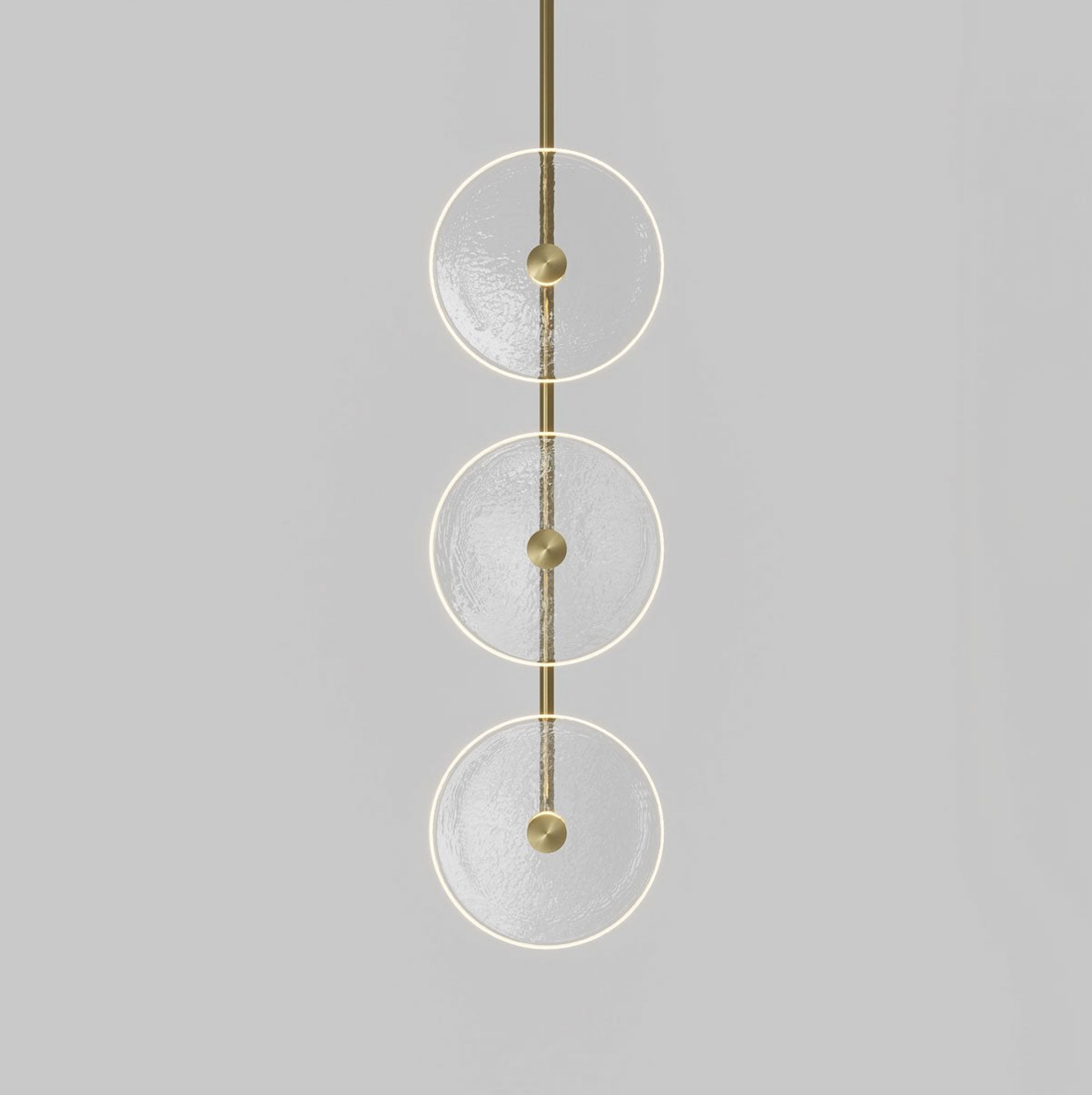 Modern pendant light with three glass circular shades on a grey background