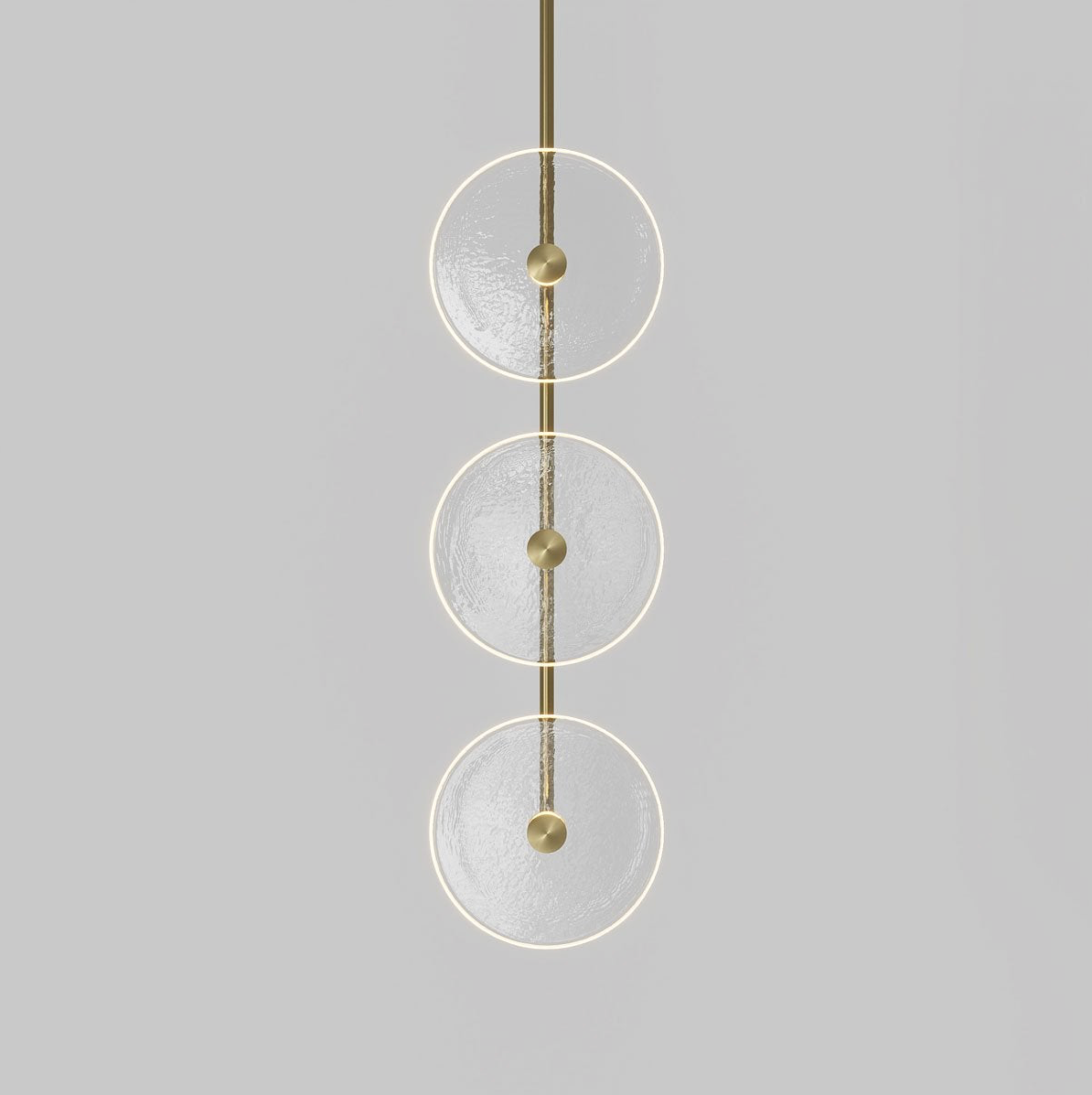 Modern pendant light with three glass circular shades on a grey background