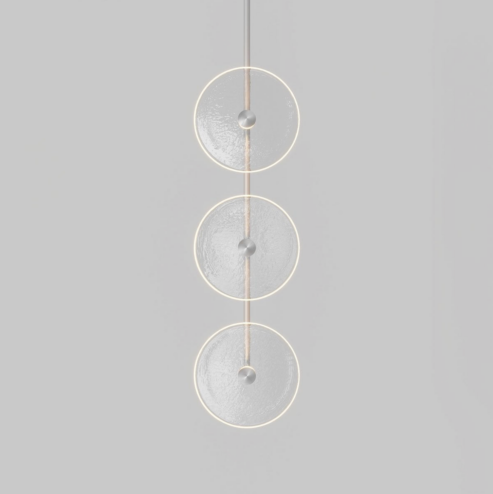 Modern pendant light with three glass circular designs on a grey background