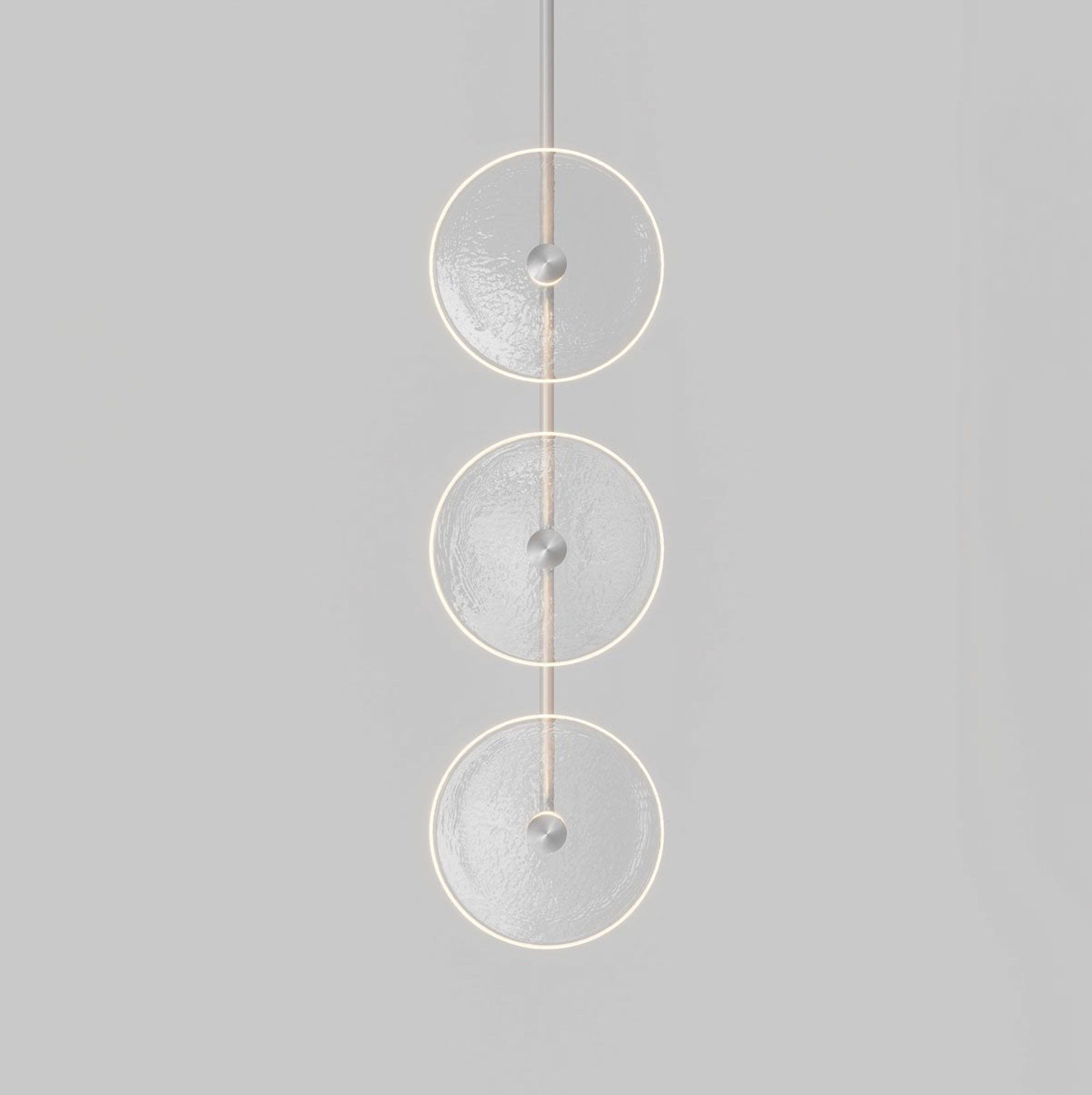 Modern pendant light with three glass circular designs on a grey background