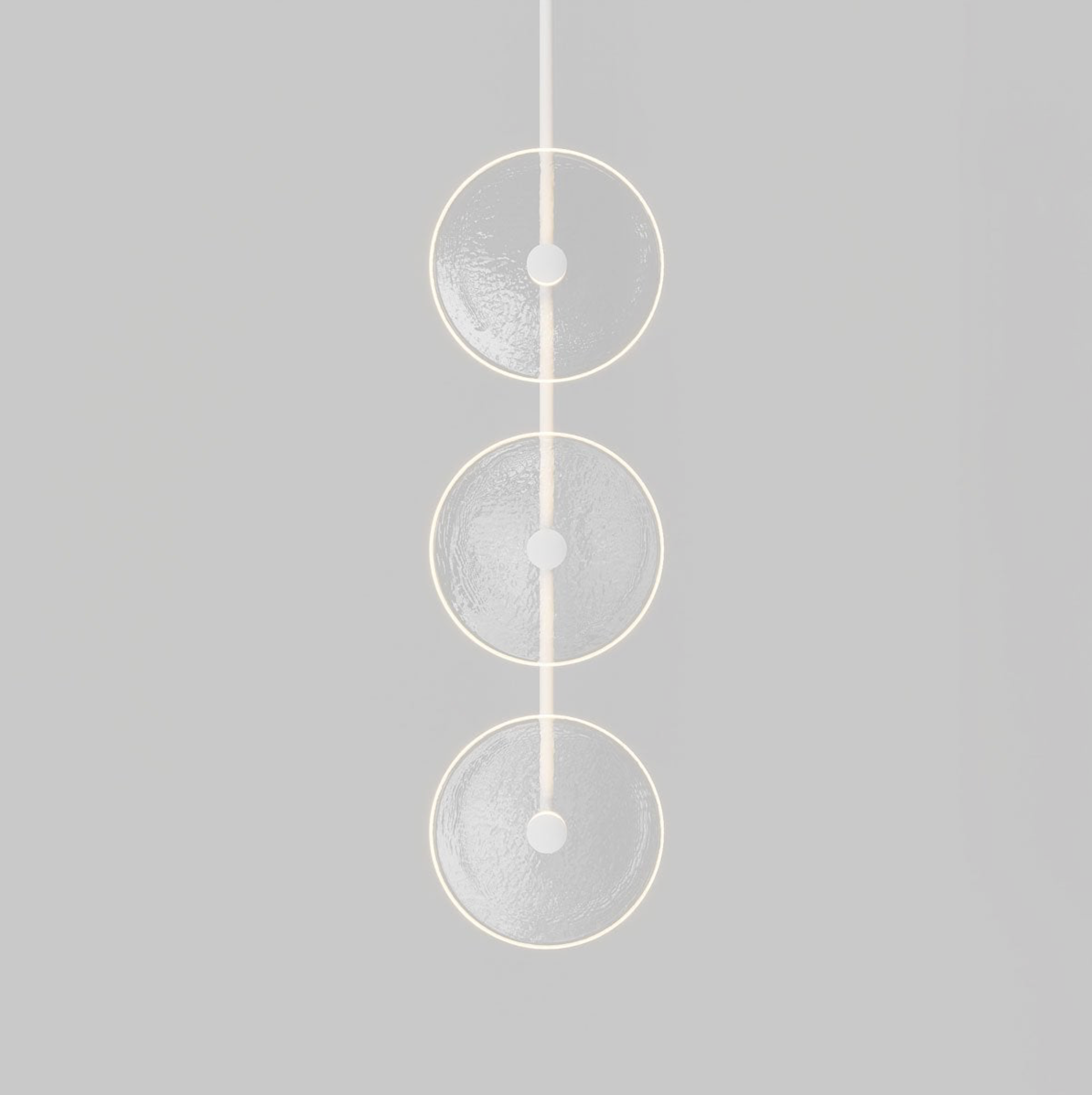 Modern pendant light with three circular glass shades on a grey background