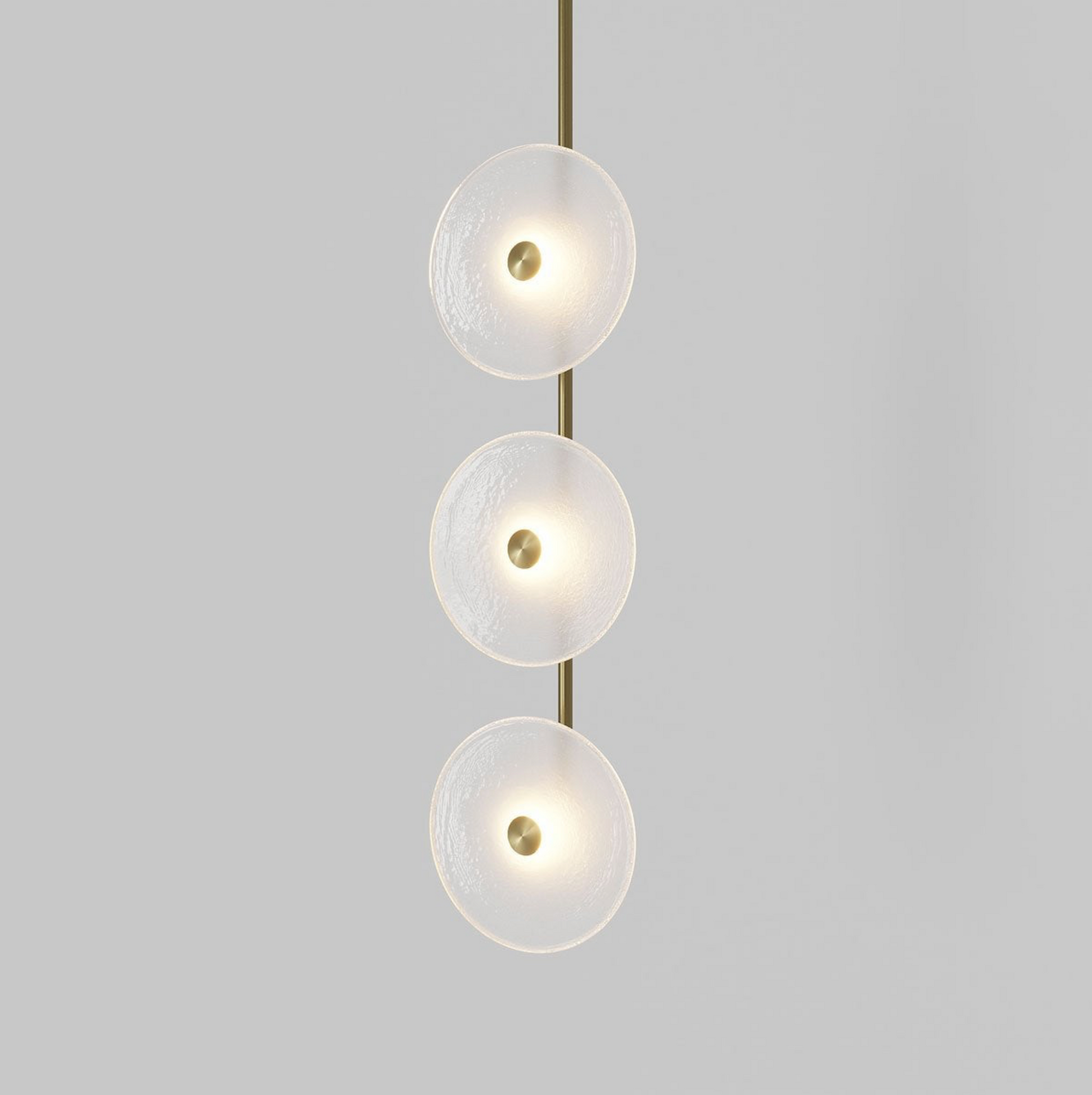 Modern pendant light with three glass shades on a gray background