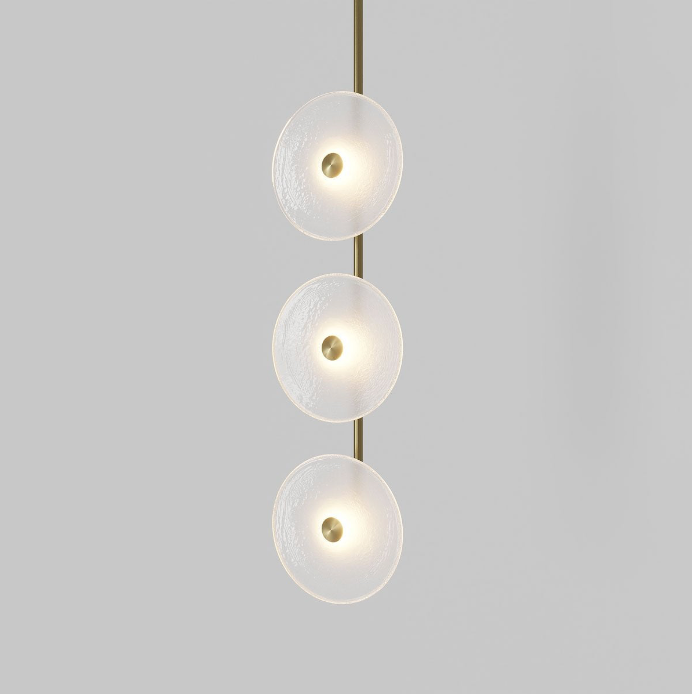 Modern pendant light with three glass shades on a gray background