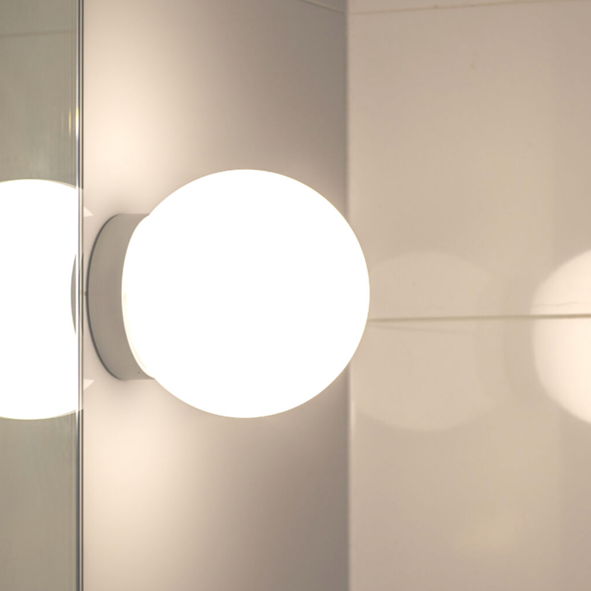 Round wall light fixture on a neutral background