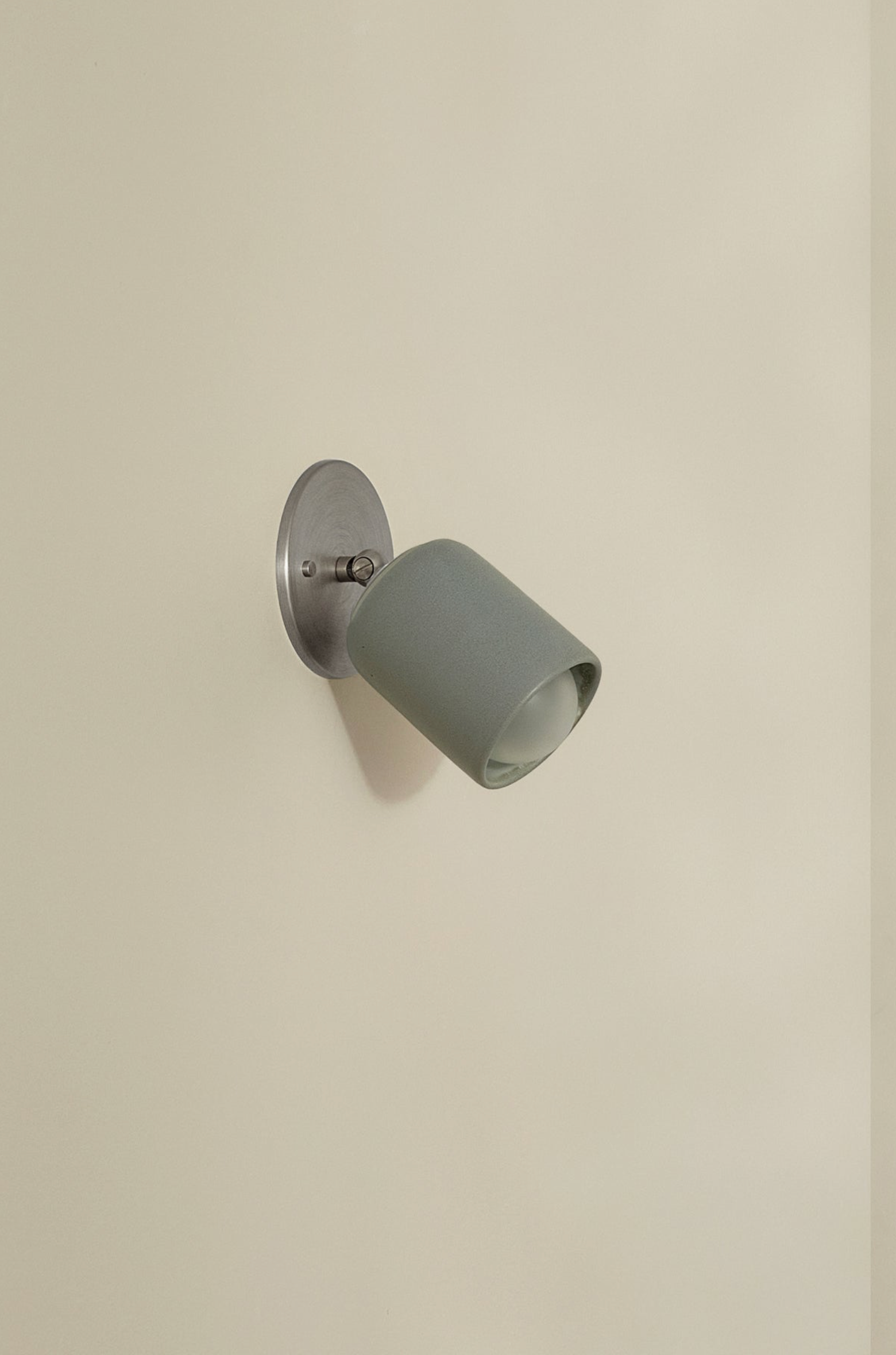 Grey wall light fixture on a beige wall