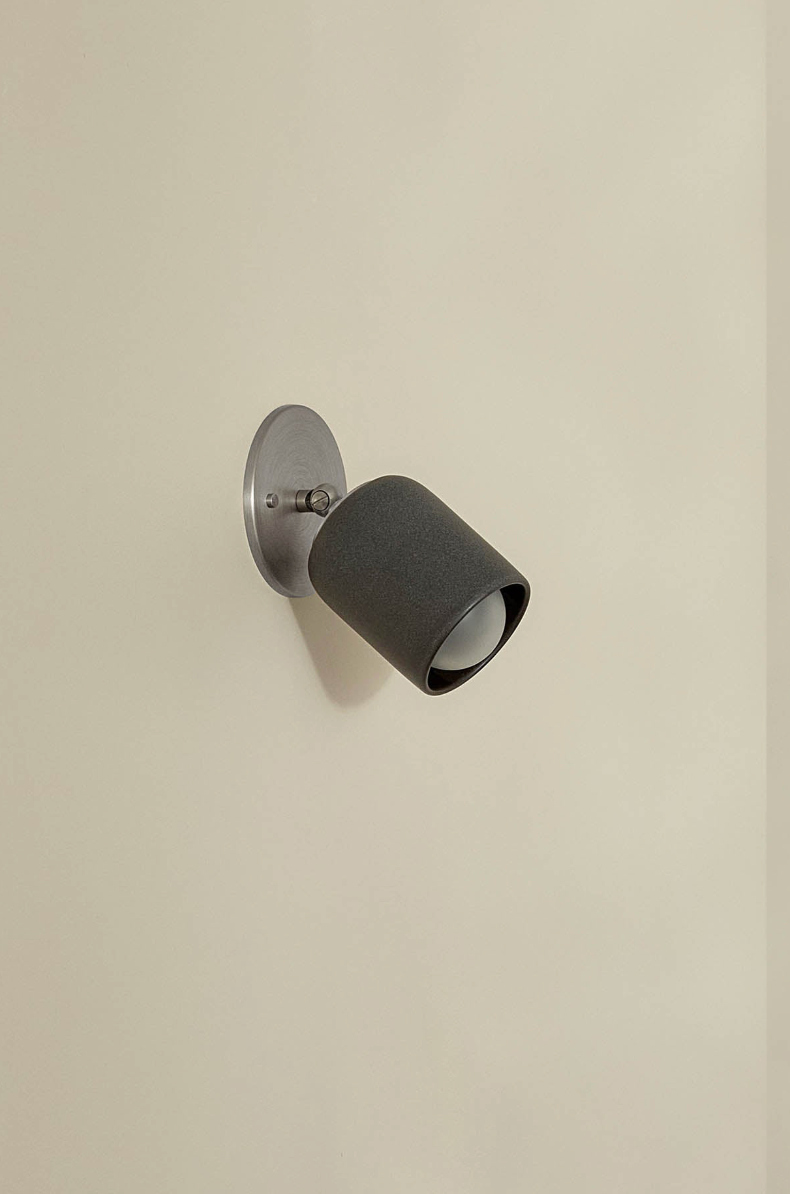 Wall-mounted indoor ceramic light fixture on a beige wall