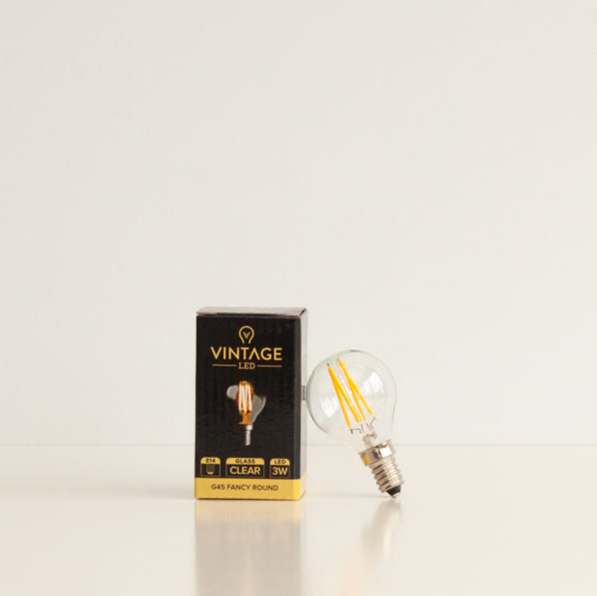 Vintage LED light bulb with packaging on a white background