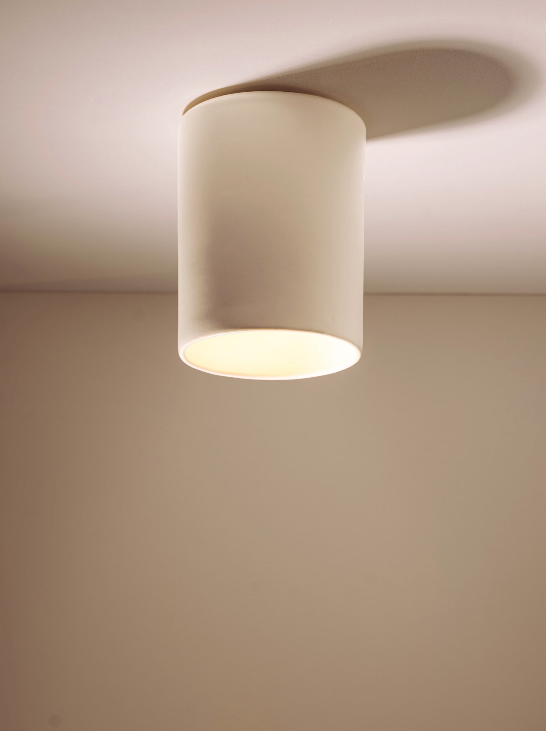 Ceramic ceiling light fixture on a plain wall