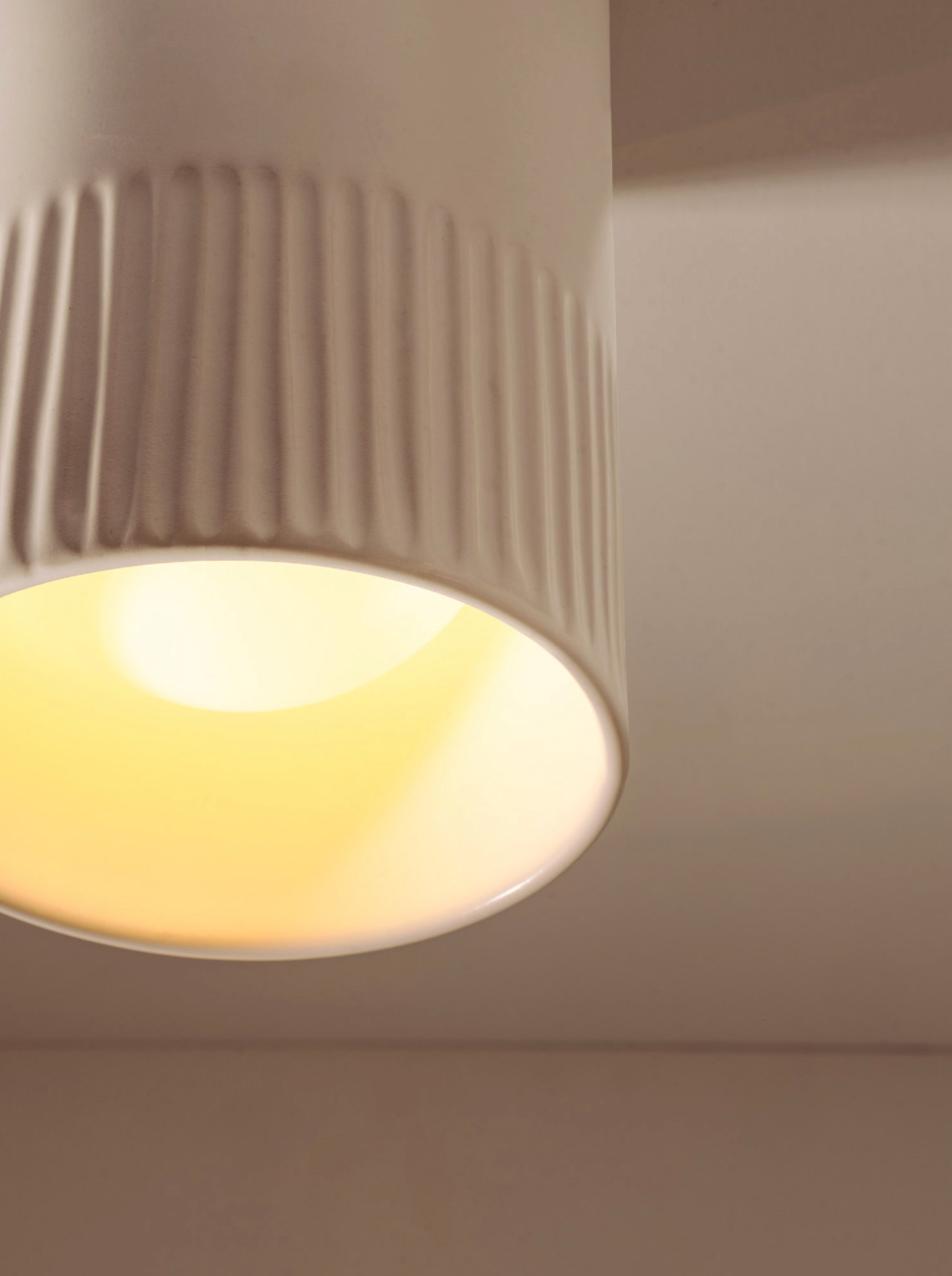 Close-up of a ceiling light fixture with a neutral background