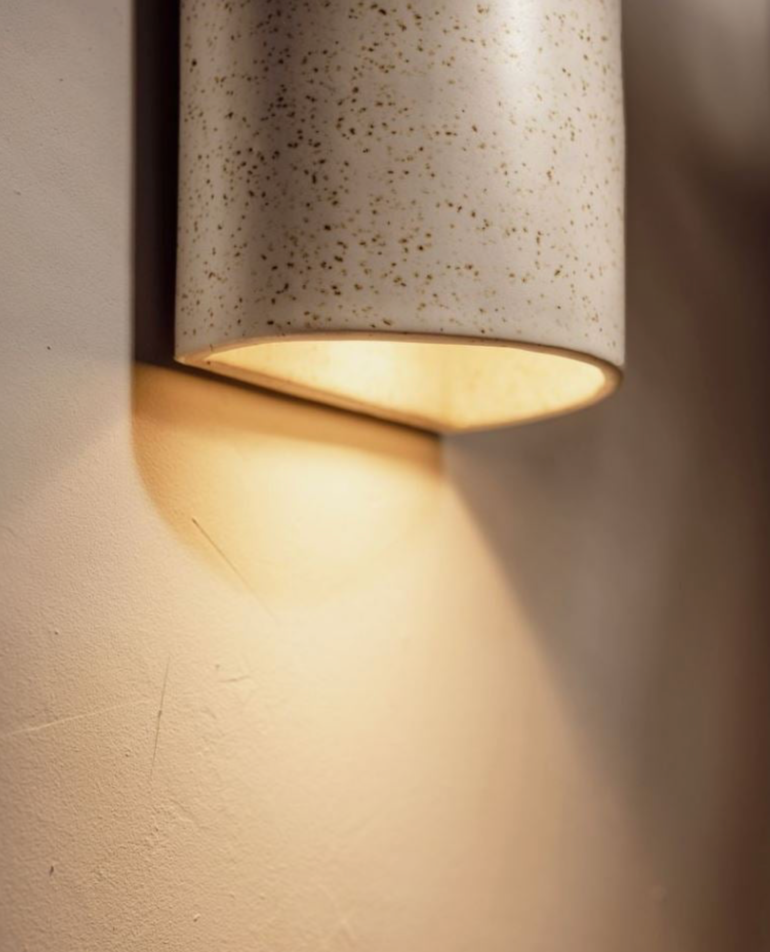 Cylindrical wall light fixture on a textured wall
