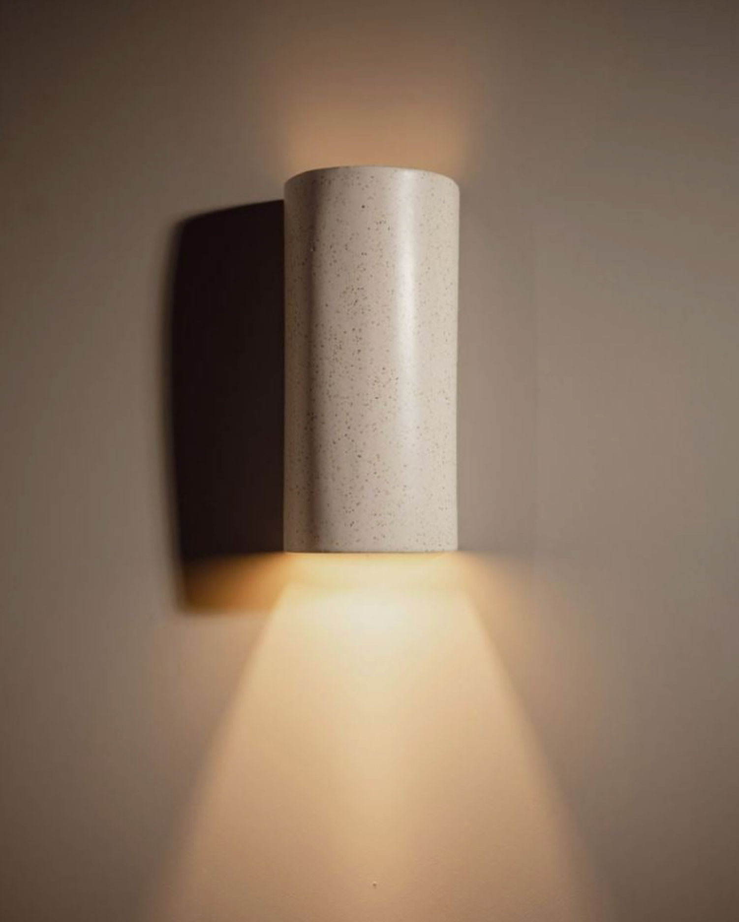 Ceramic wall light fixture on a neutral background