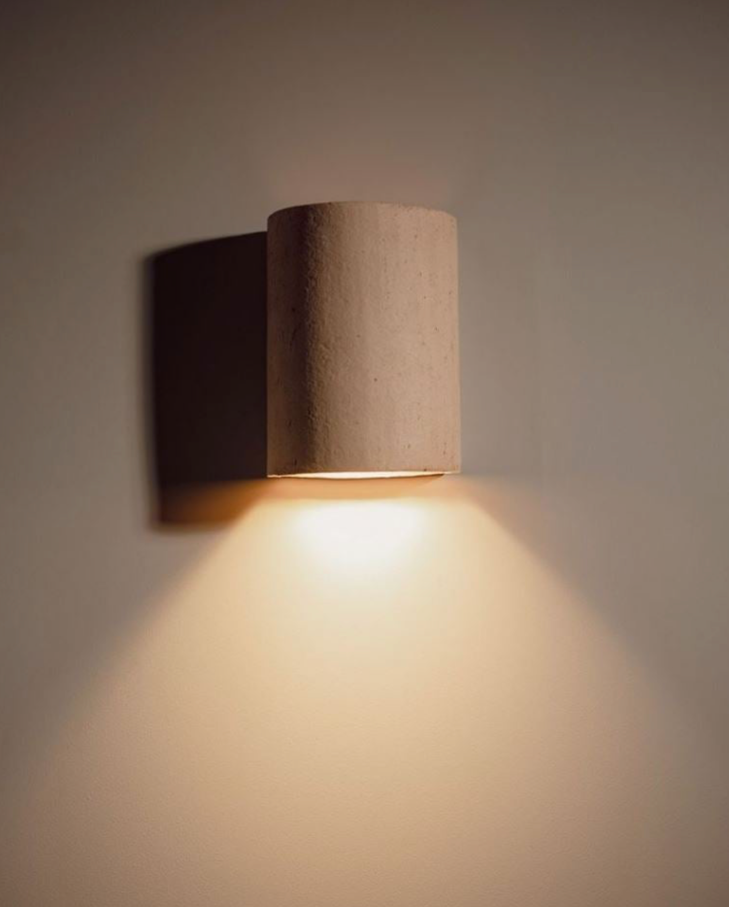Cylindrical wall light fixture on a plain wall