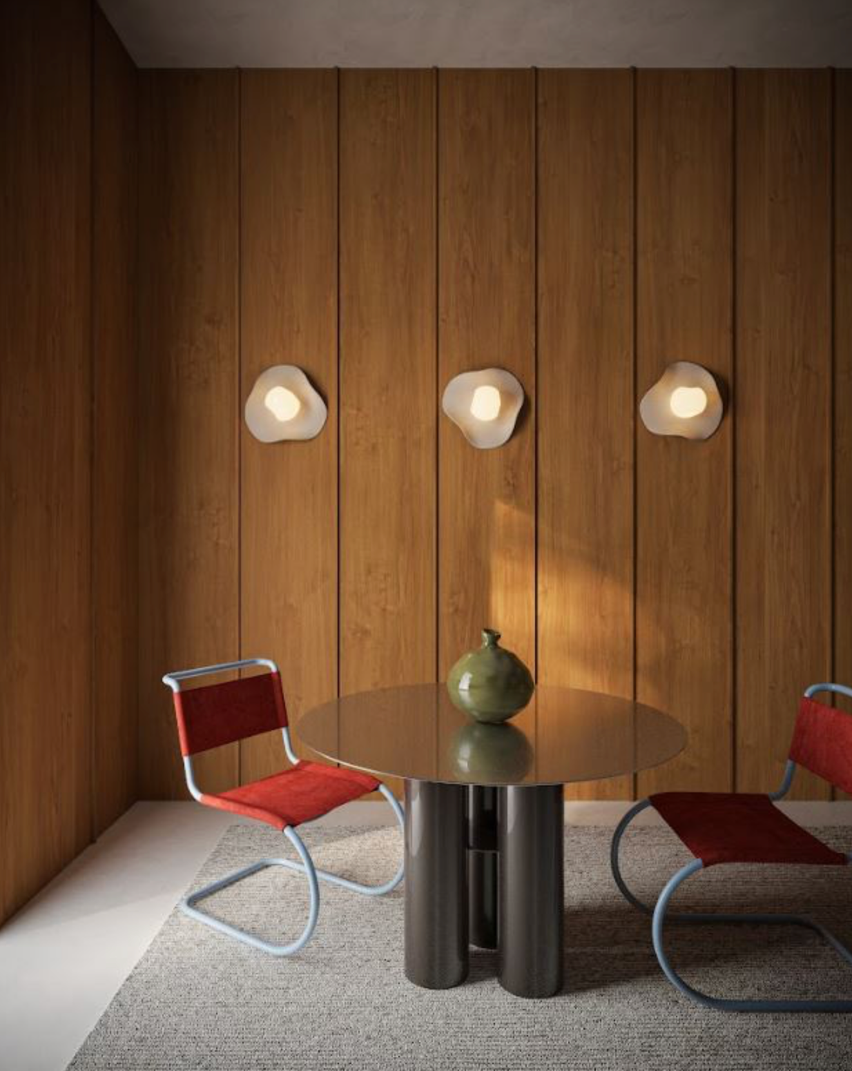 Modern interior wall lights on a wooden wall, round table, and mid century red chairs.