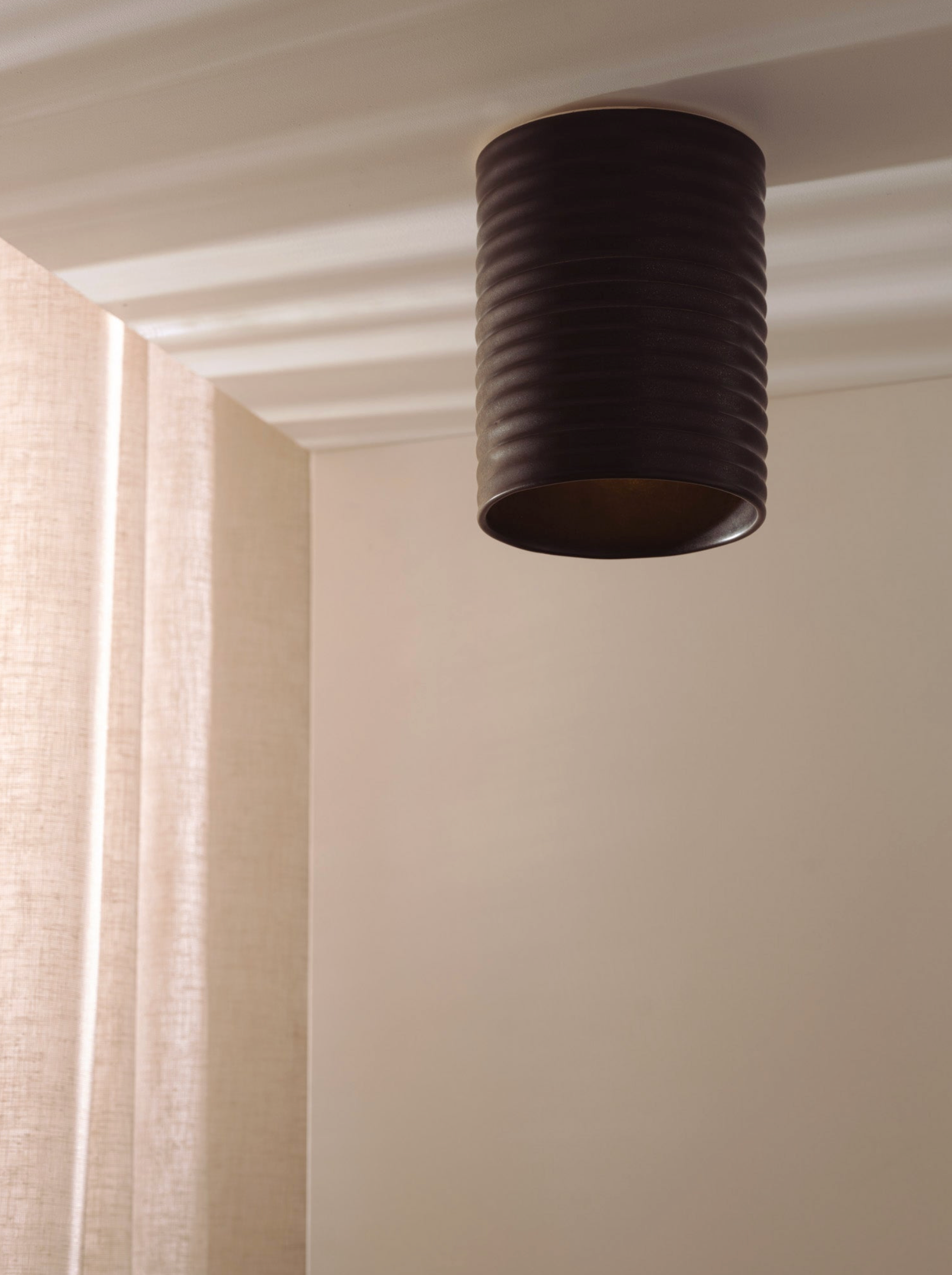 Black ceiling light fixture on a white ceiling