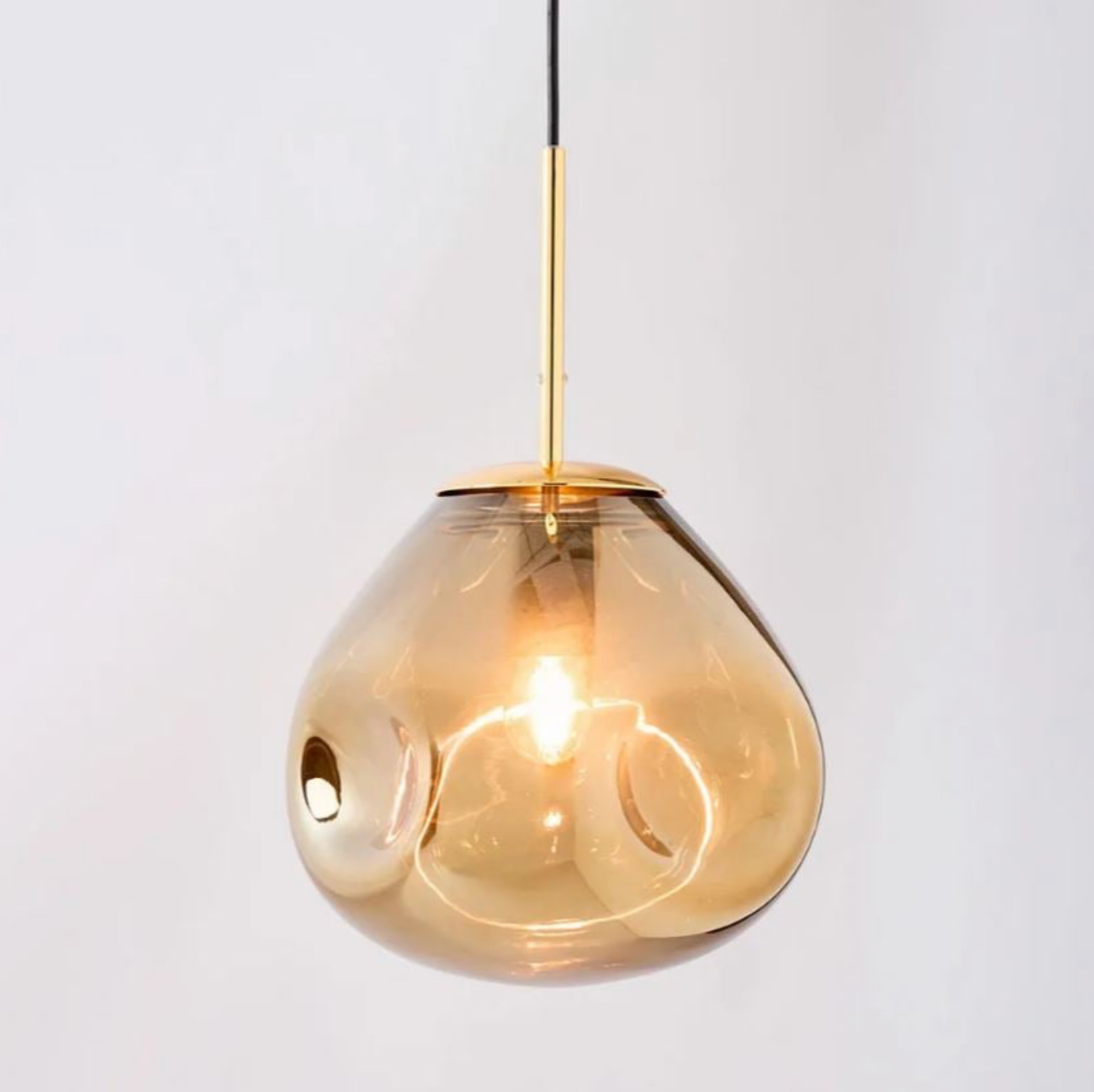 Gold pendant light on a white background