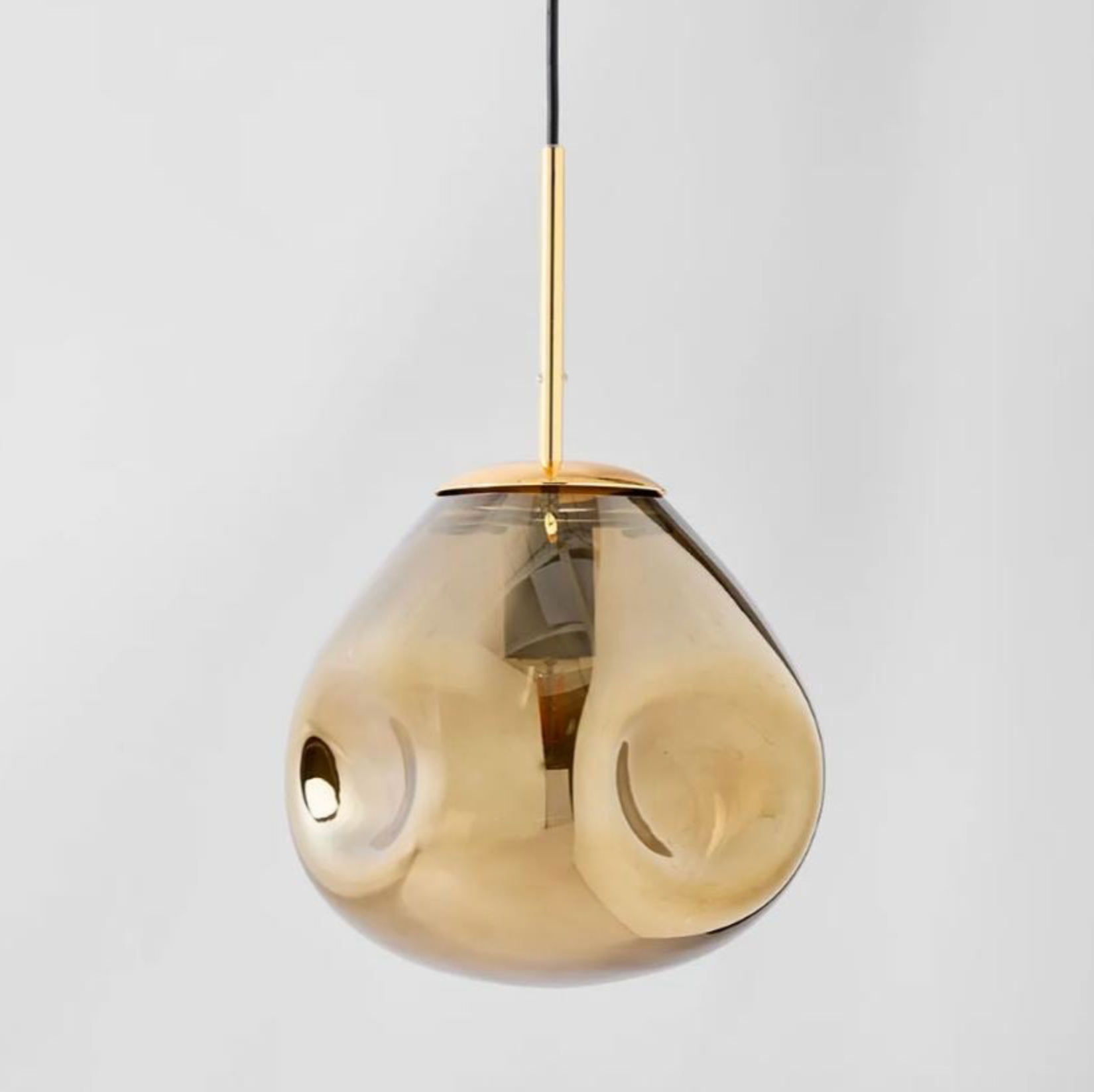 Gold pendant light on a grey background