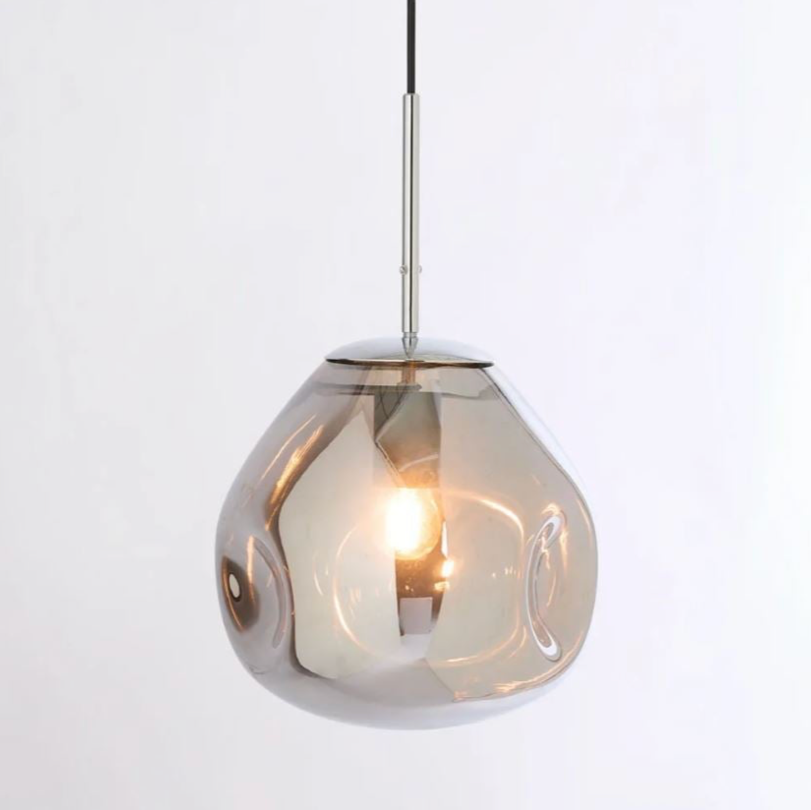 Pendant light with a reflective glass shade on a white background