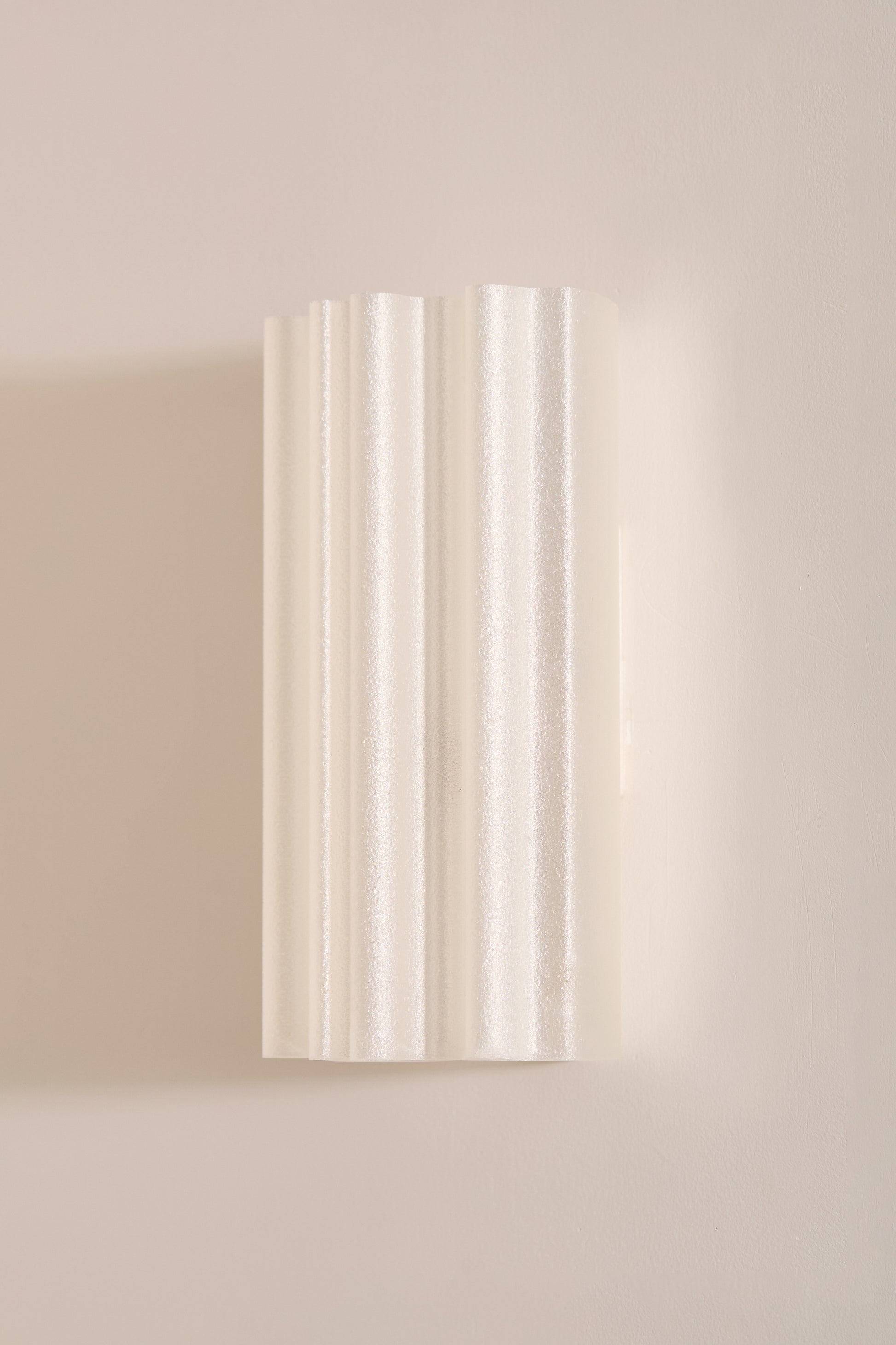 Chloe Wall Light Pearl fluted 3D printed PLA shade unlit angled view on beige wall – Franca Studio
