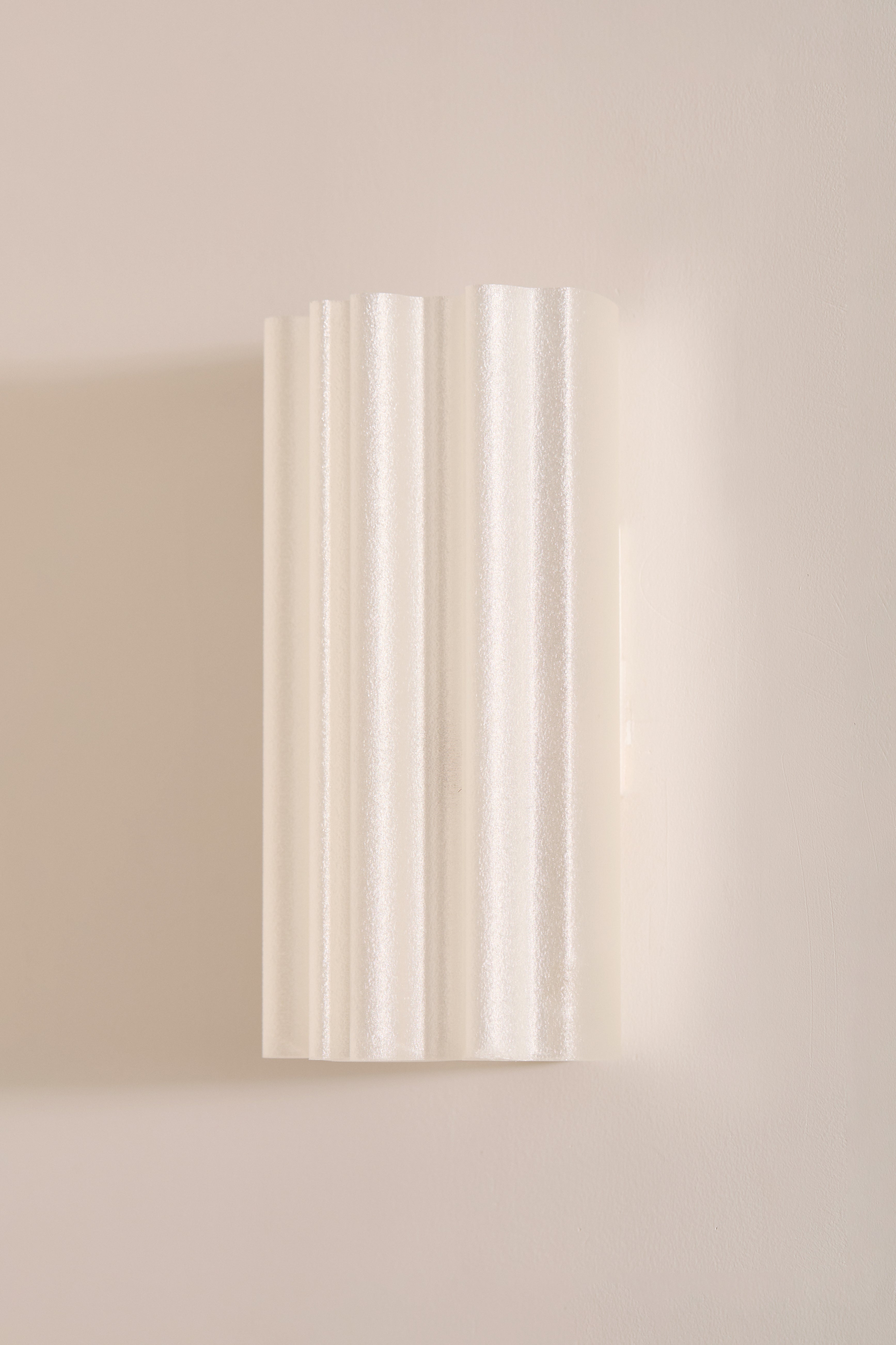 Chloe Wall Light Pearl fluted 3D printed PLA shade unlit angled view on beige wall – Franca Studio
