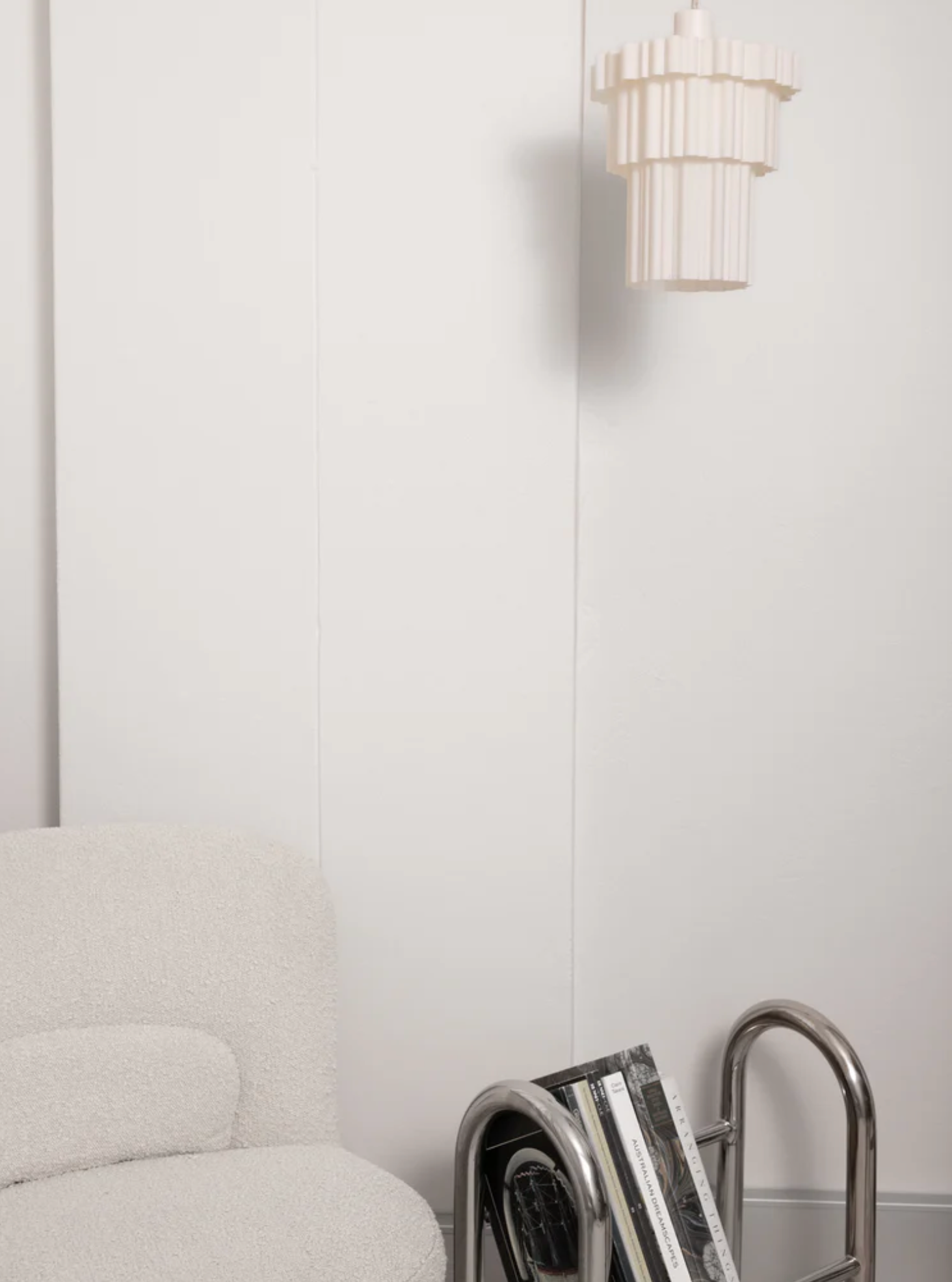 Delphine Pendant Light Pearl three-tiered 3D printed shade hanging in styled living room with grey sofa – Franca Studio