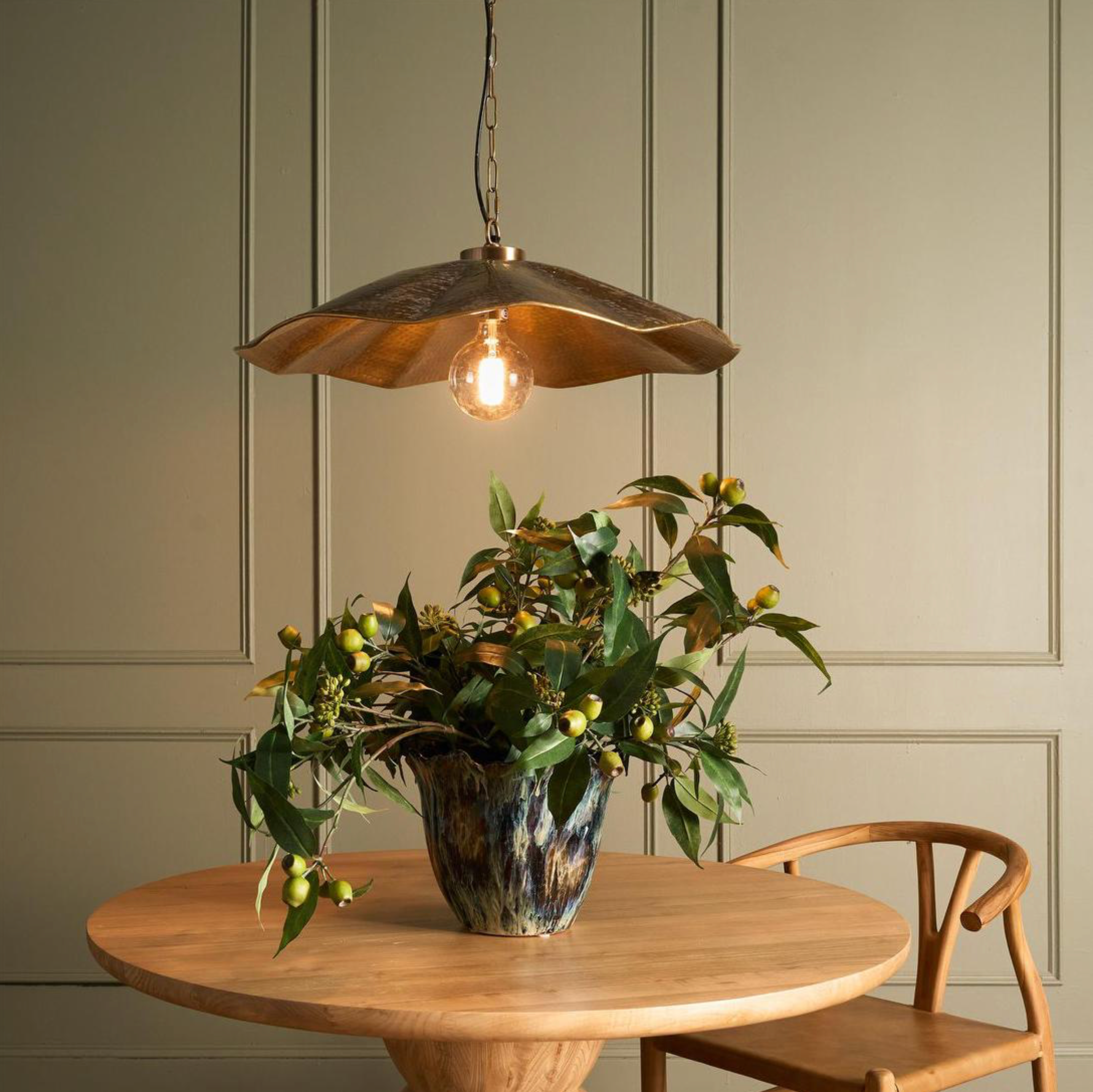 Melville Antique Brass Pendant Light above timber dining table with botanical arrangement – Lightingales
